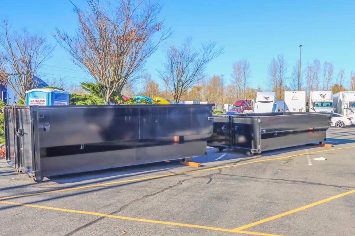 Professional dumpster rental service with roll-off container on residential driveway in Los Fresnos